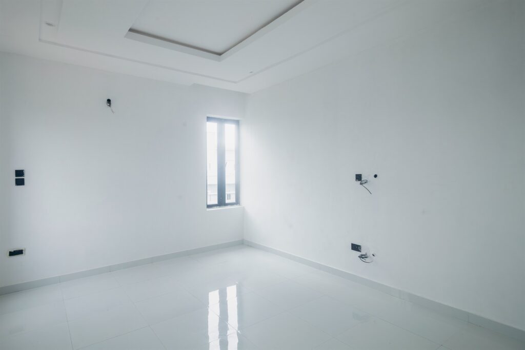 Brum Height 5: Unfurnished bedroom with a recessed ceiling and window